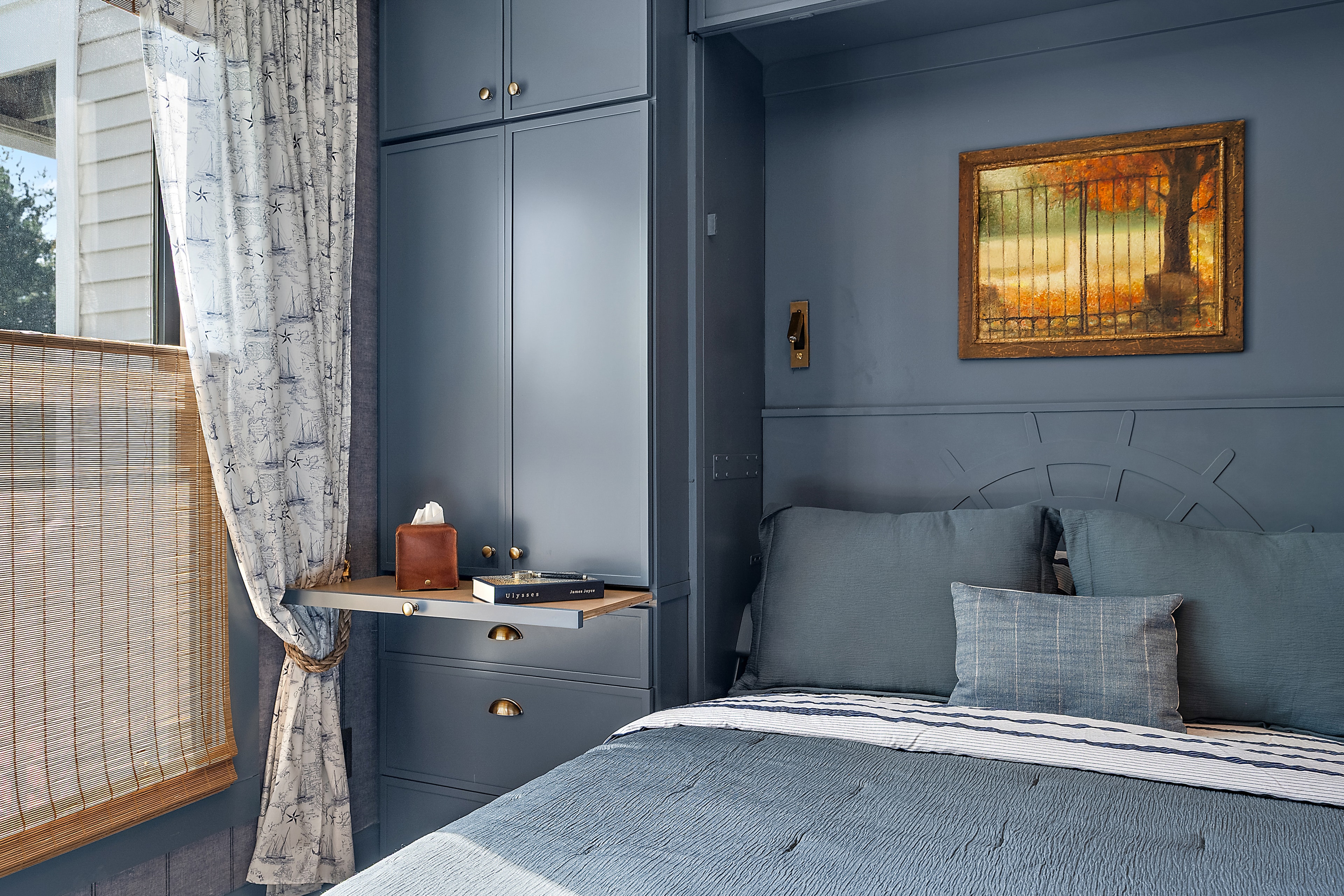 Modern bedroom with blue walls and built-in wardrobe