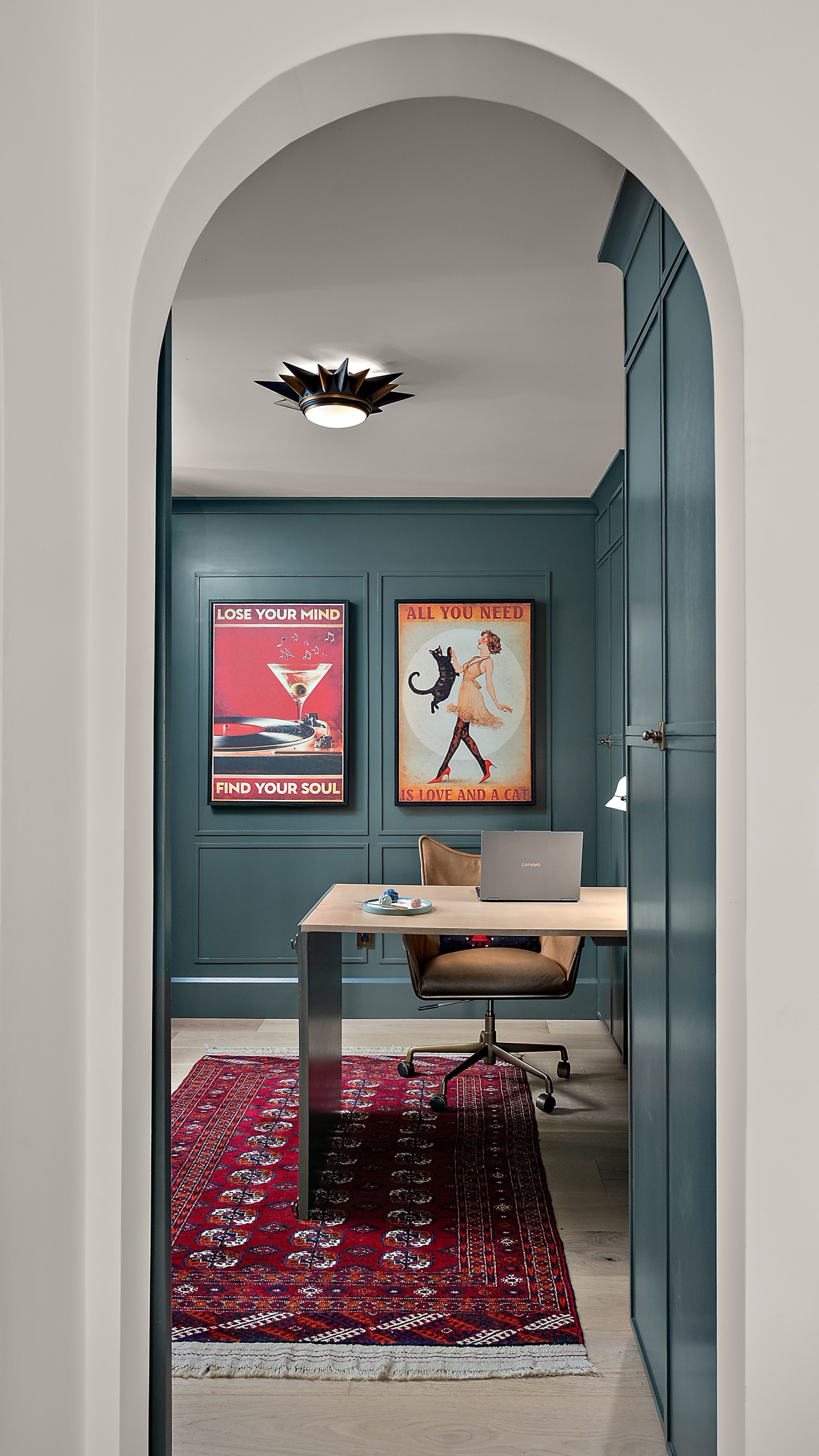 Modern home office through arched doorway
