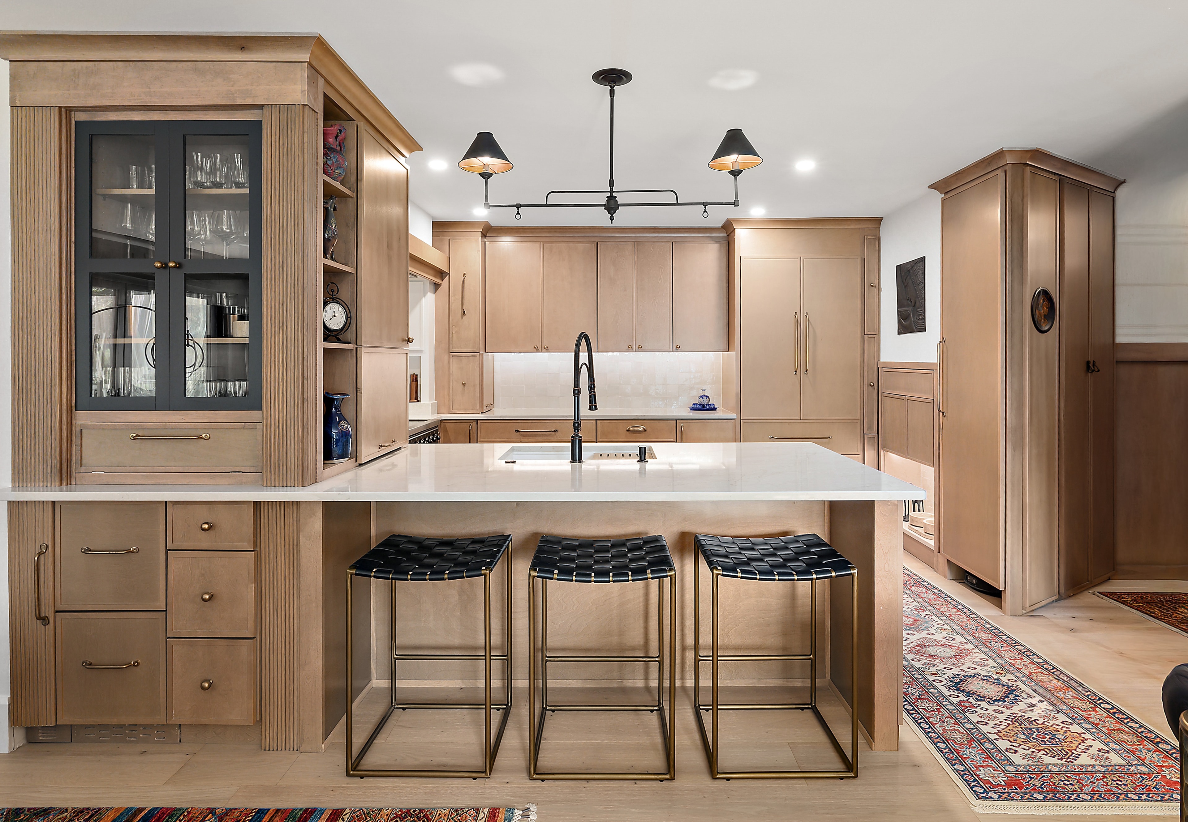 Modern kitchen with wood cabinetry and island seating